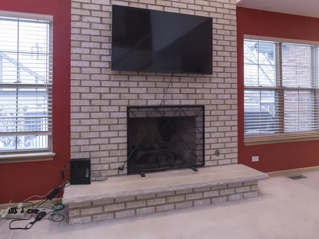 a living room with a fireplace and a flat screen tv