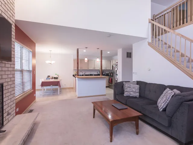a living room with furniture and kitchen view