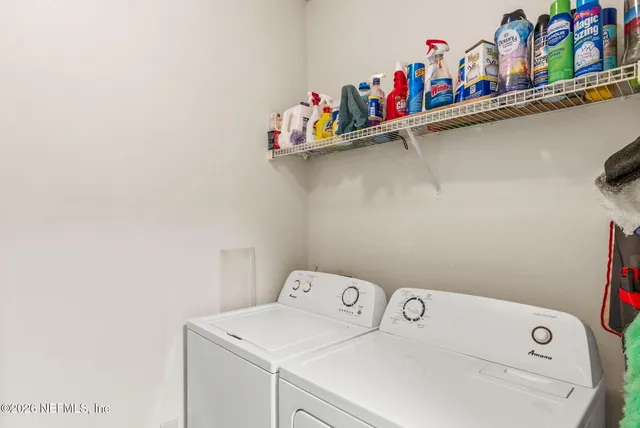 a view of a dining room with furniture and a potted plant