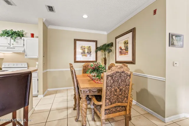 a living room with furniture a rug and a chandelier