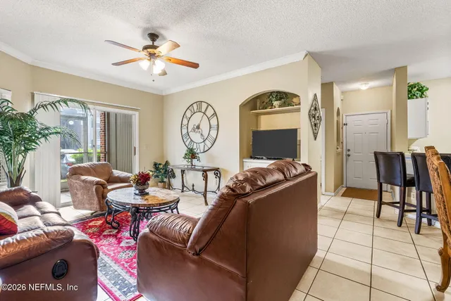 a spacious bedroom with a large bed and a chandelier