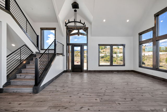 300 Knoll Loop, Unit 227 Fish Haven, ID 83287 - Photo 6 of 56 Entrance foyer with french doors, light wood-style flooring, vaulted ceiling, a chandelier, and plenty of natural light