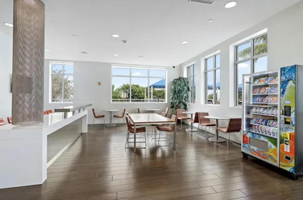a living room with fireplace furniture and a large window