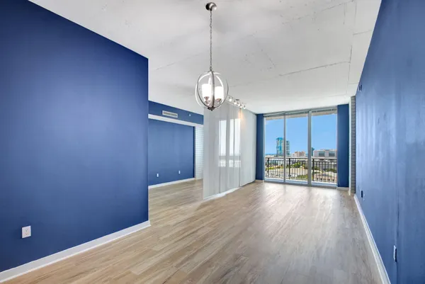 a view of a livingroom with wooden floor and a window