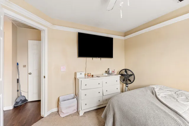 a bedroom with a bed and a flat screen tv