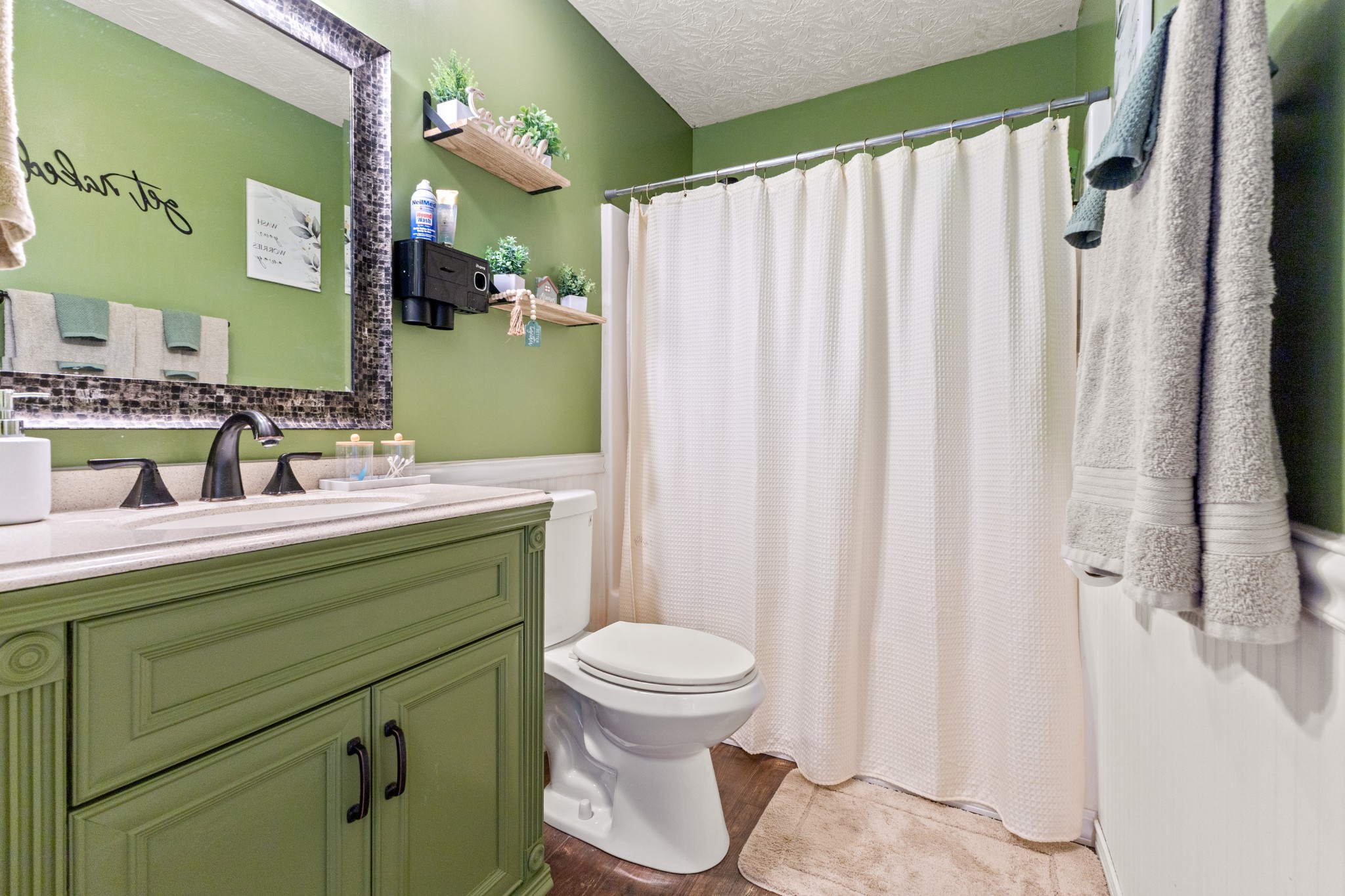 205 Emerald Circle Pleasant View, TN 37146 - Photo 17 of 22 a bathroom with a sink a toilet and shower curtain
