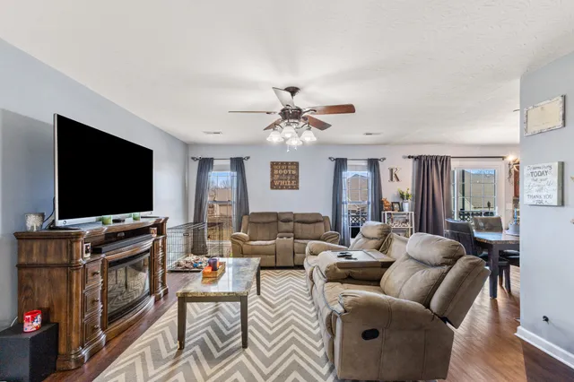 a living room with furniture and a flat screen tv