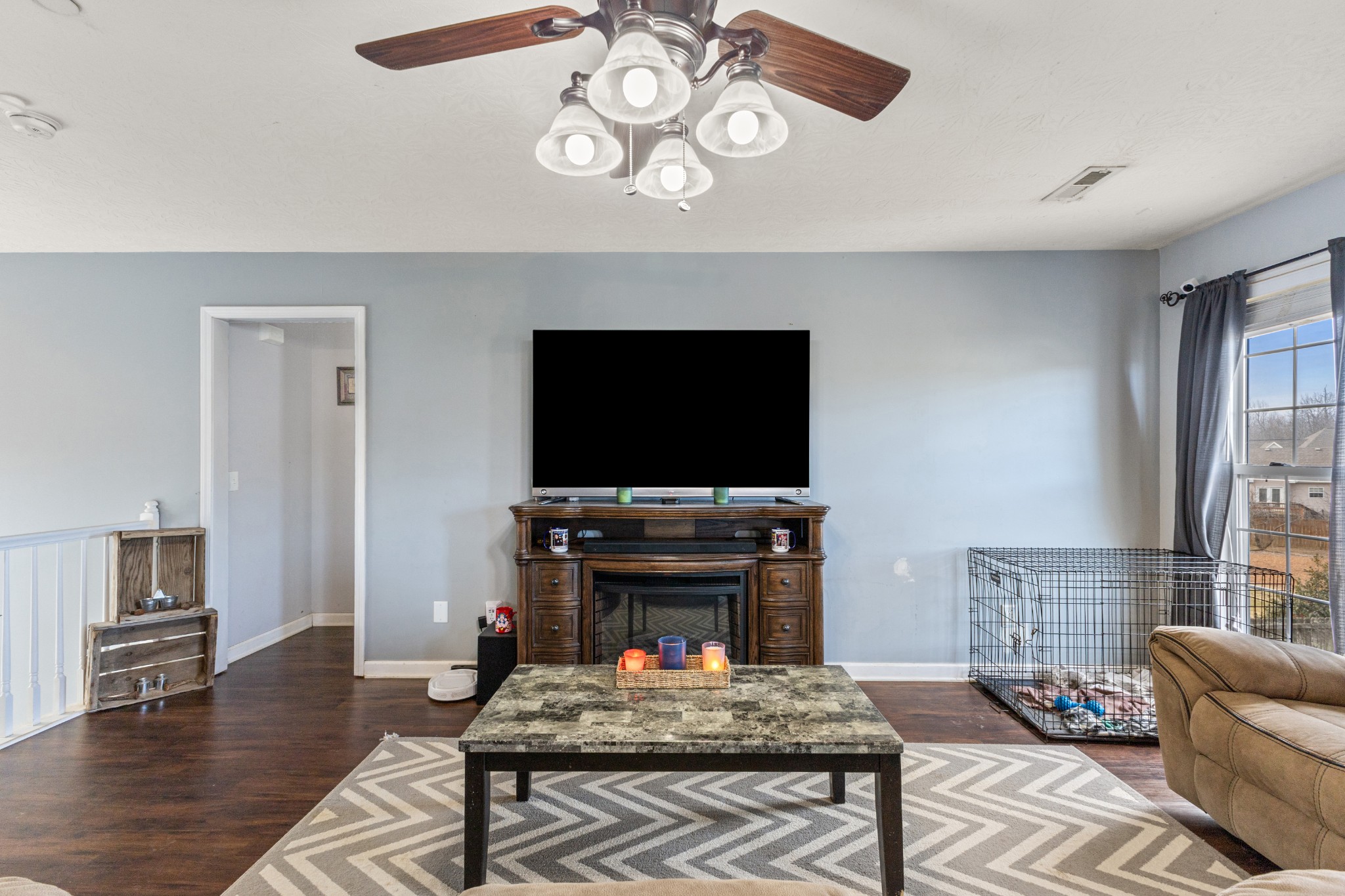 205 Emerald Circle Pleasant View, TN 37146 - Photo 5 of 22 a living room with furniture a flat screen tv and a fireplace