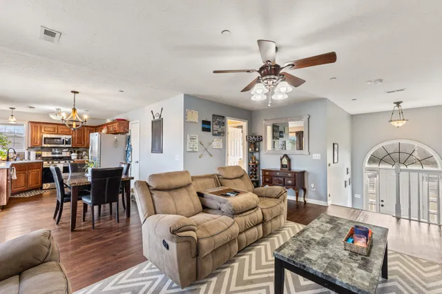 a living room with furniture a dining table and a fireplace