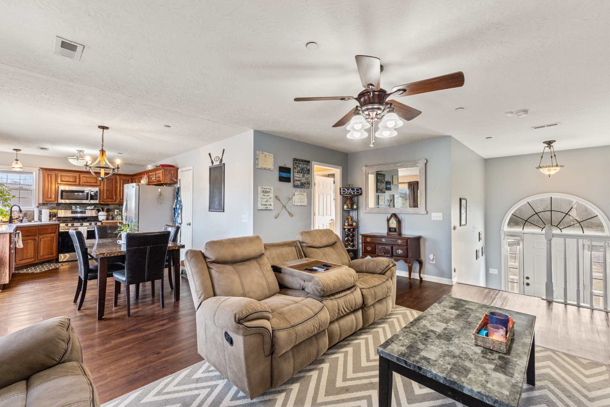 205 Emerald Circle Pleasant View, TN 37146 - Photo 6 of 22 a living room with furniture a dining table and a fireplace