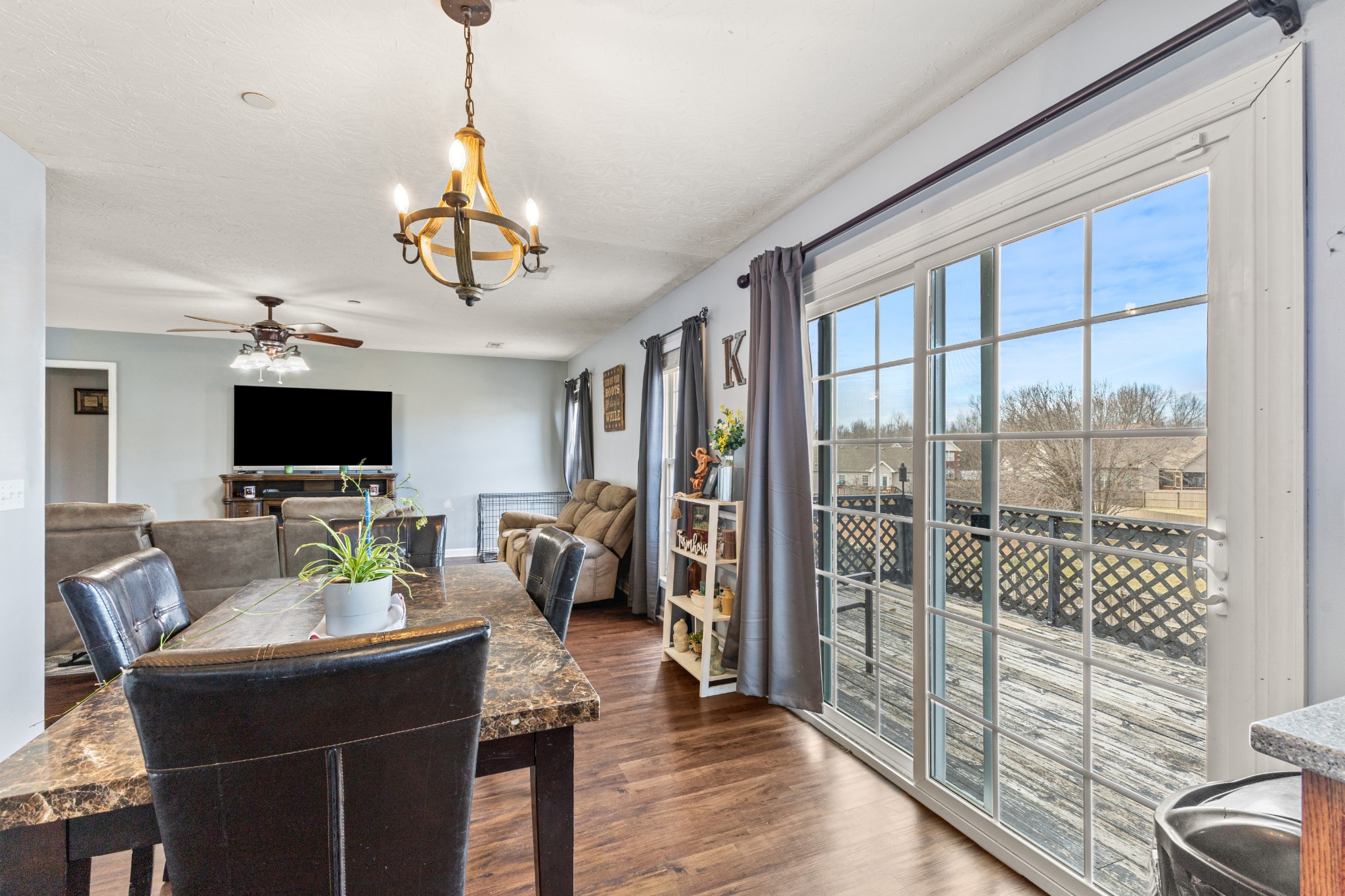 205 Emerald Circle Pleasant View, TN 37146 - Photo 7 of 22 a living room with furniture a flat screen tv and a floor to ceiling window