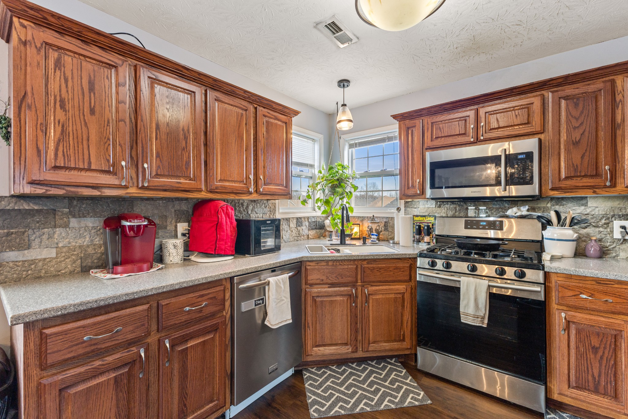 205 Emerald Circle Pleasant View, TN 37146 - Photo 8 of 22 a kitchen with stainless steel appliances granite countertop a stove sink microwave and cabinets