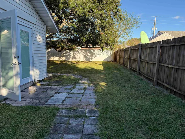 a view of a yard with a large tree