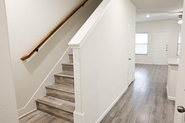 802 South 5th Street, Unit 1 Bonham, TX 75418 - Photo 15 of 25 Staircase with wood-finish treads and a natural wood handrail