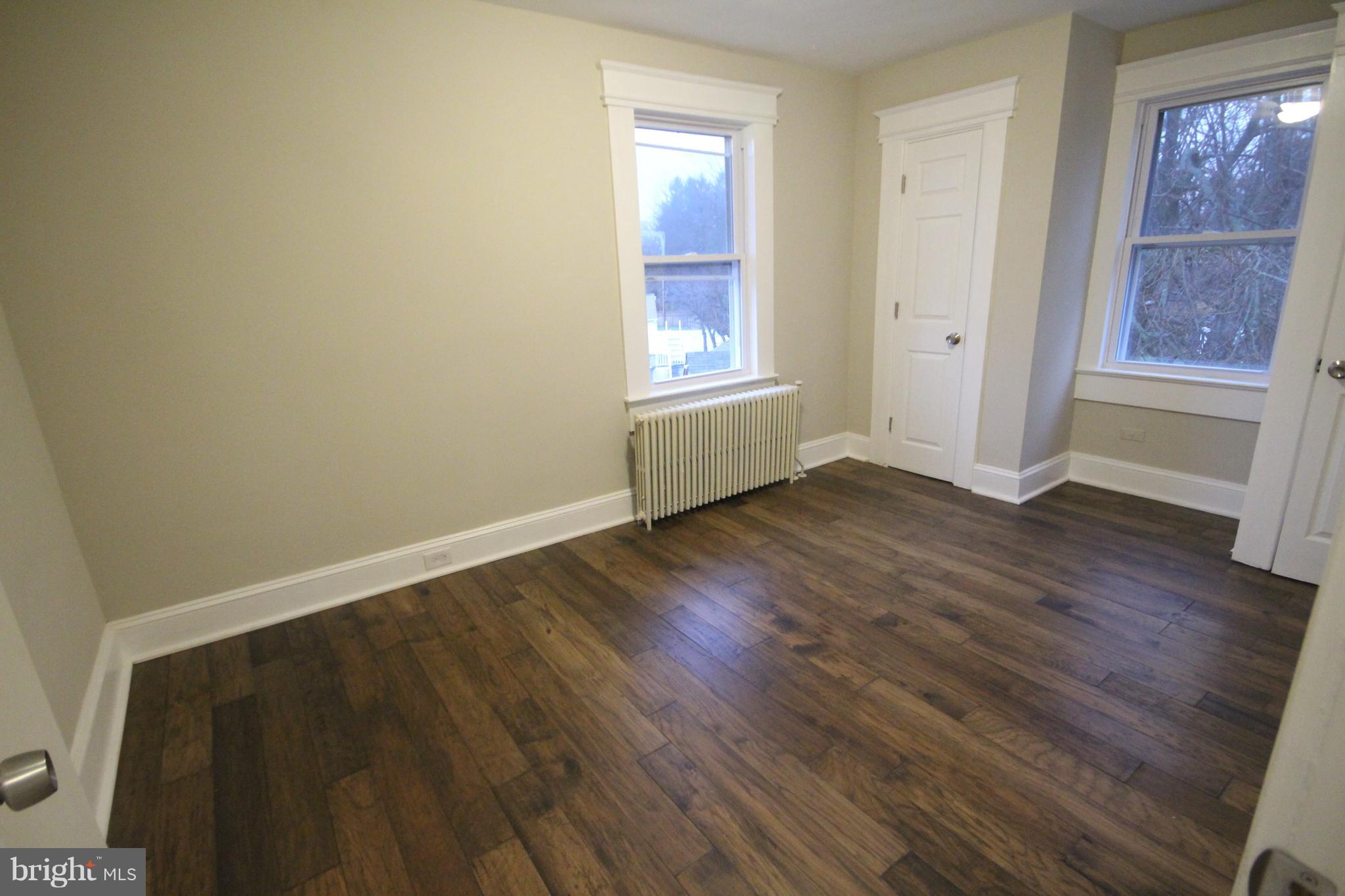 162 Edinburg Road Hamilton, NJ 08619 - Photo 12 of 17 an empty room with wooden floor and windows