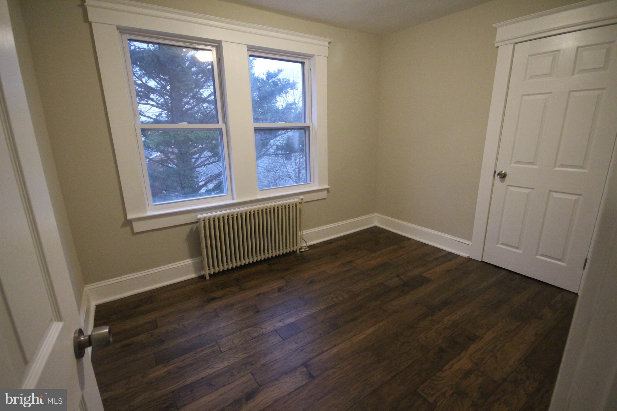 162 Edinburg Road Hamilton, NJ 08619 - Photo 13 of 17 an empty room with wooden floor and windows