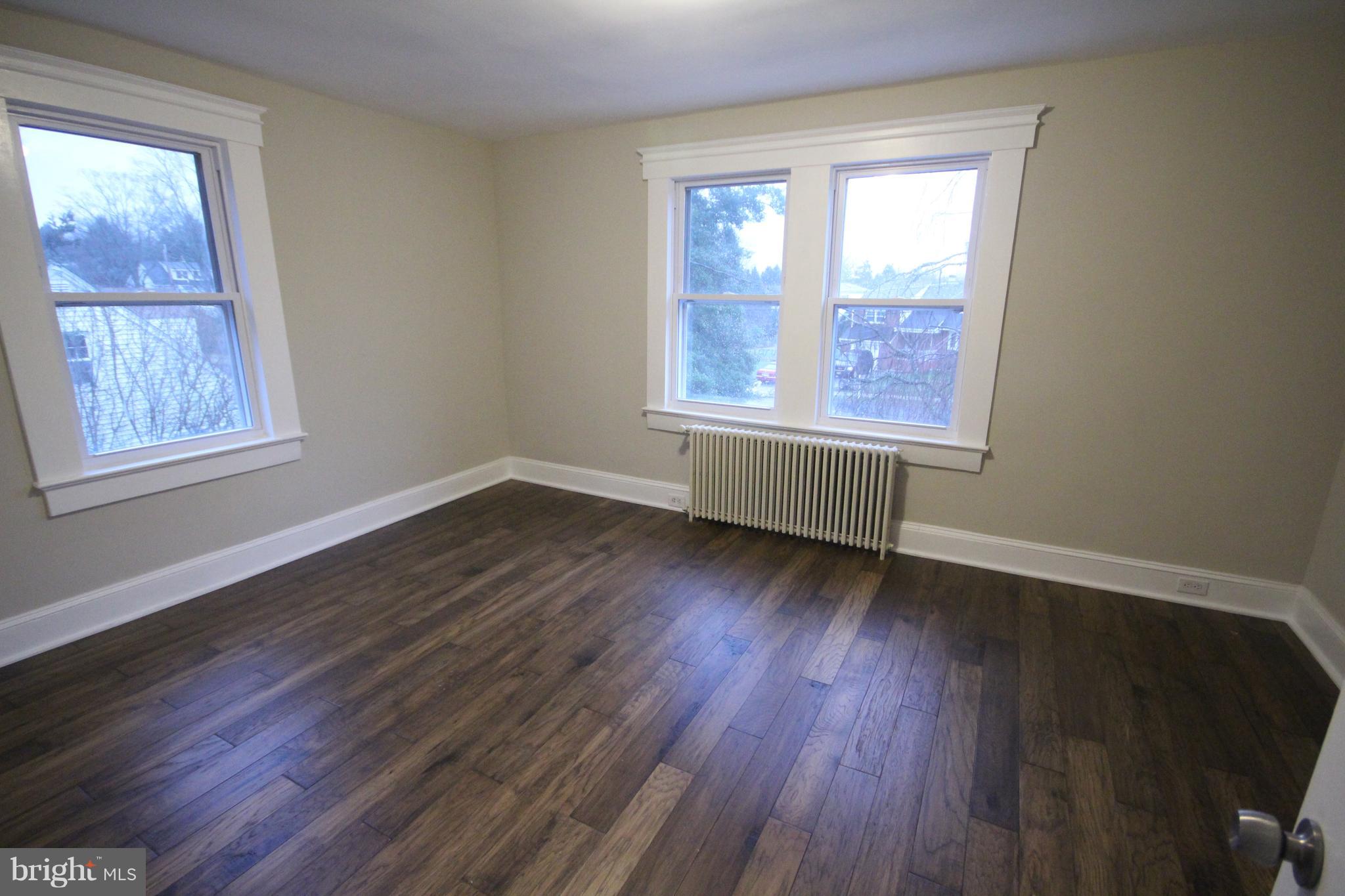 162 Edinburg Road Hamilton, NJ 08619 - Photo 14 of 17 a view of an empty room with wooden floor and a window