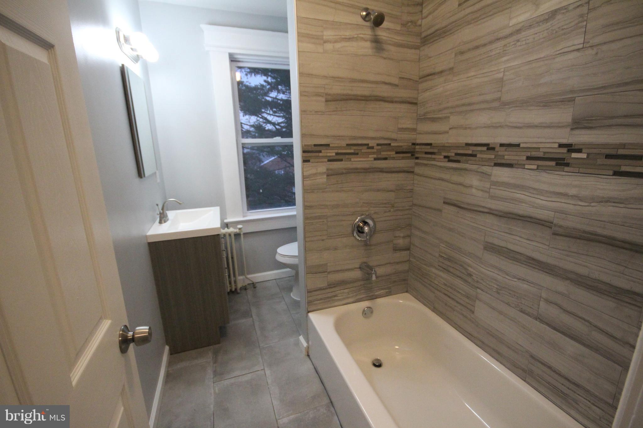 162 Edinburg Road Hamilton, NJ 08619 - Photo 15 of 17 a bathroom with a bathtub and shower