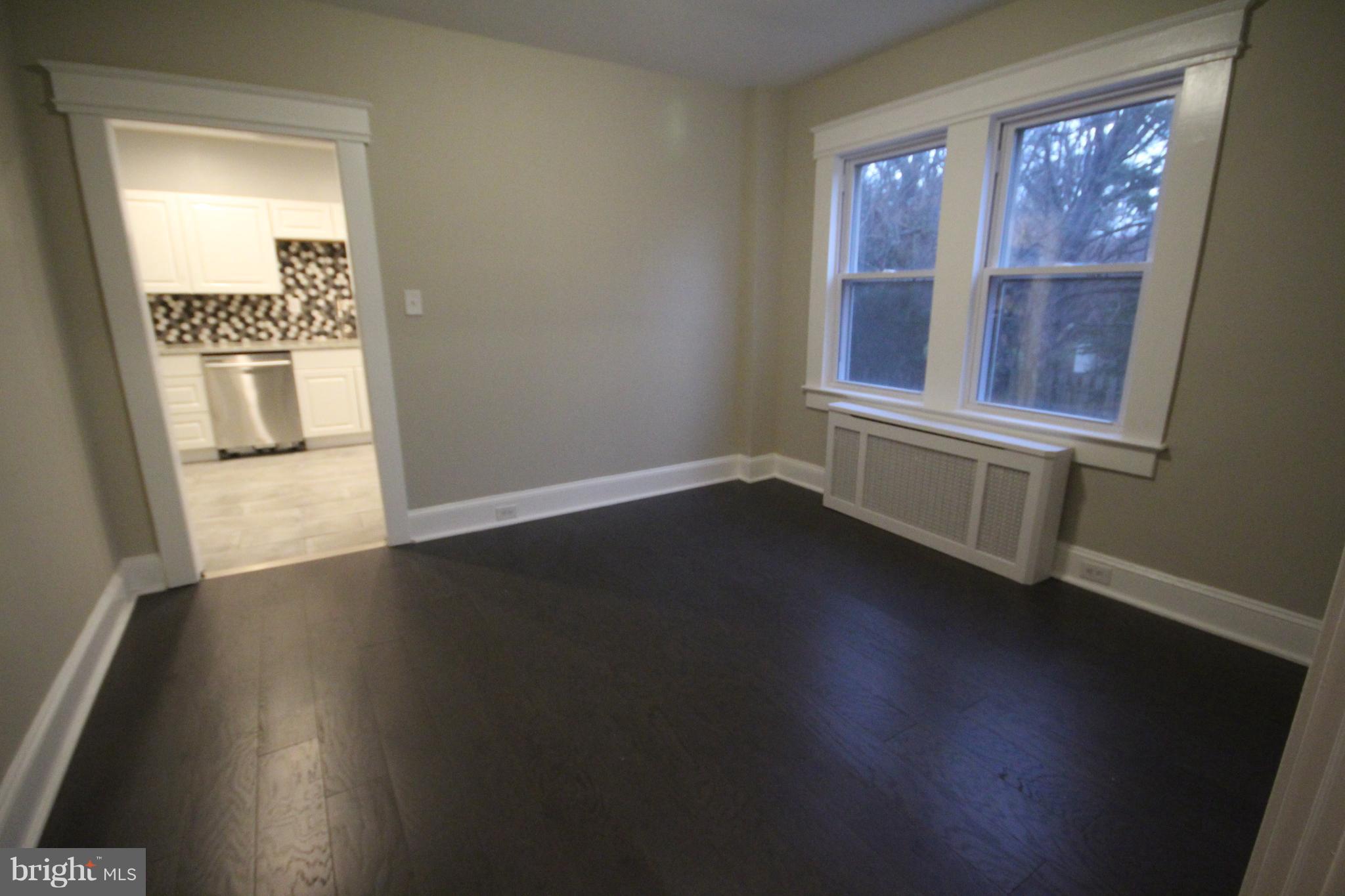 162 Edinburg Road Hamilton, NJ 08619 - Photo 7 of 17 an empty room with wooden floor and windows