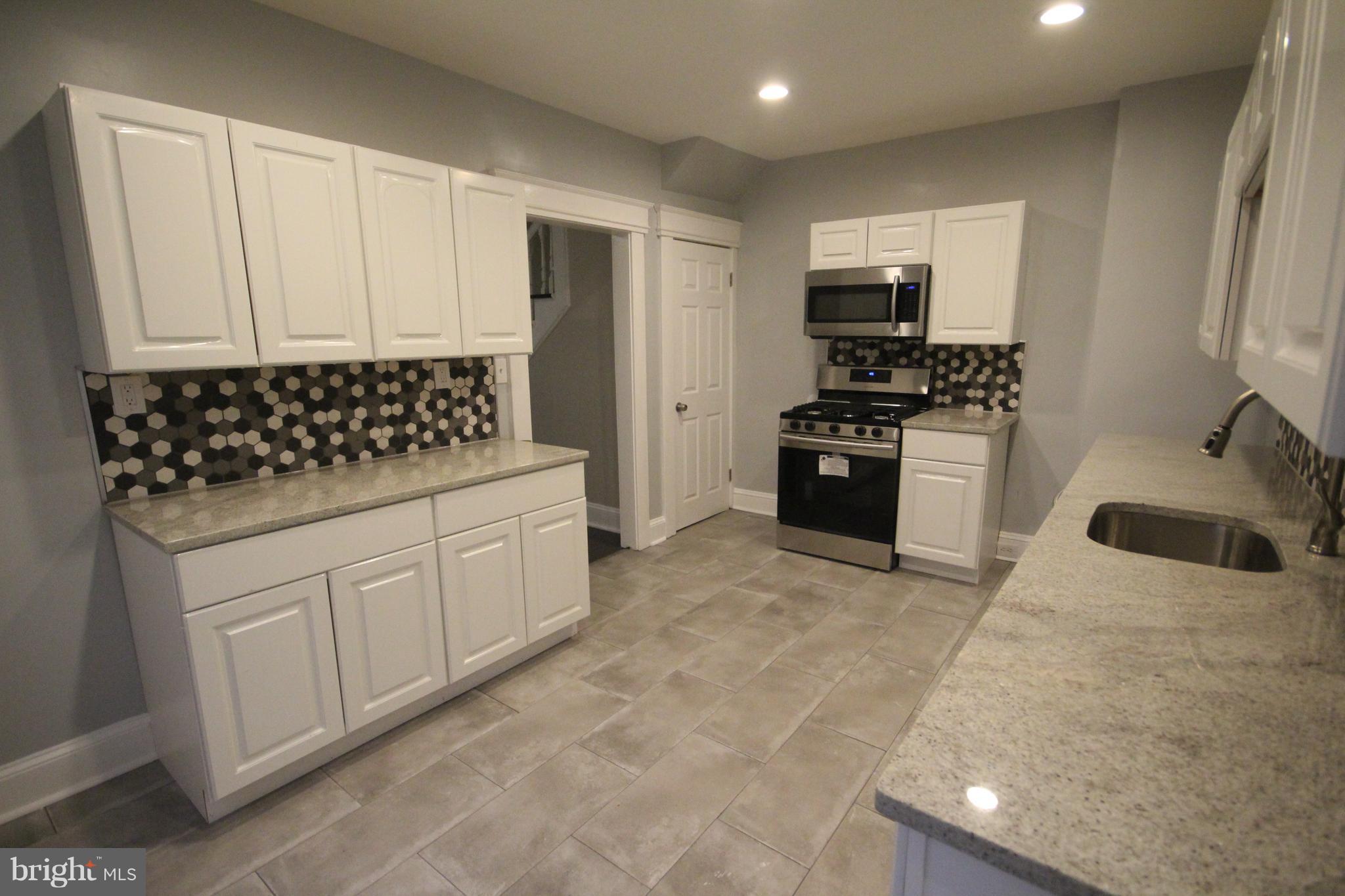 162 Edinburg Road Hamilton, NJ 08619 - Photo 8 of 17 a kitchen with a sink a stove and refrigerator