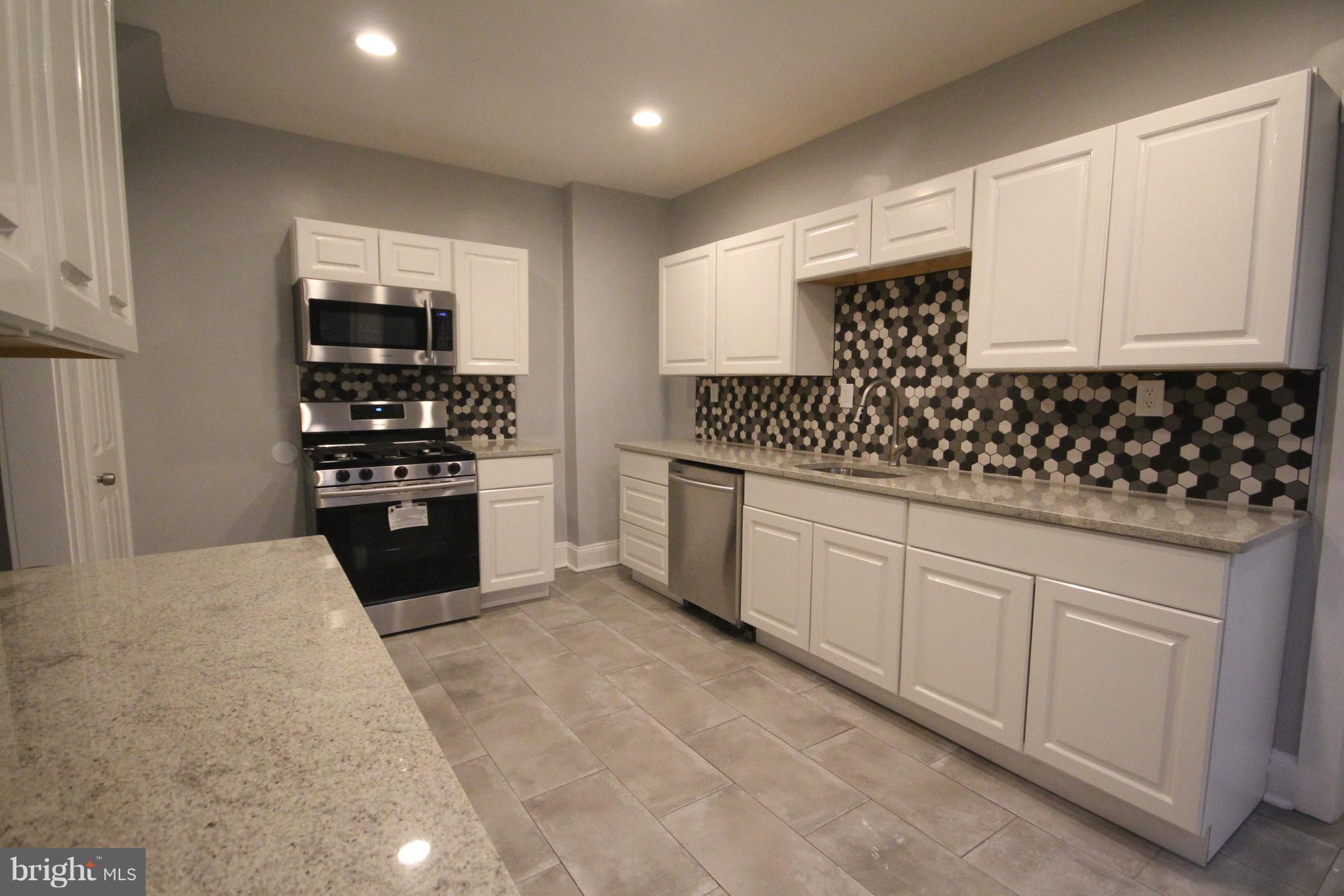 162 Edinburg Road Hamilton, NJ 08619 - Photo 9 of 17 a kitchen with stainless steel appliances kitchen island granite countertop a sink and cabinets