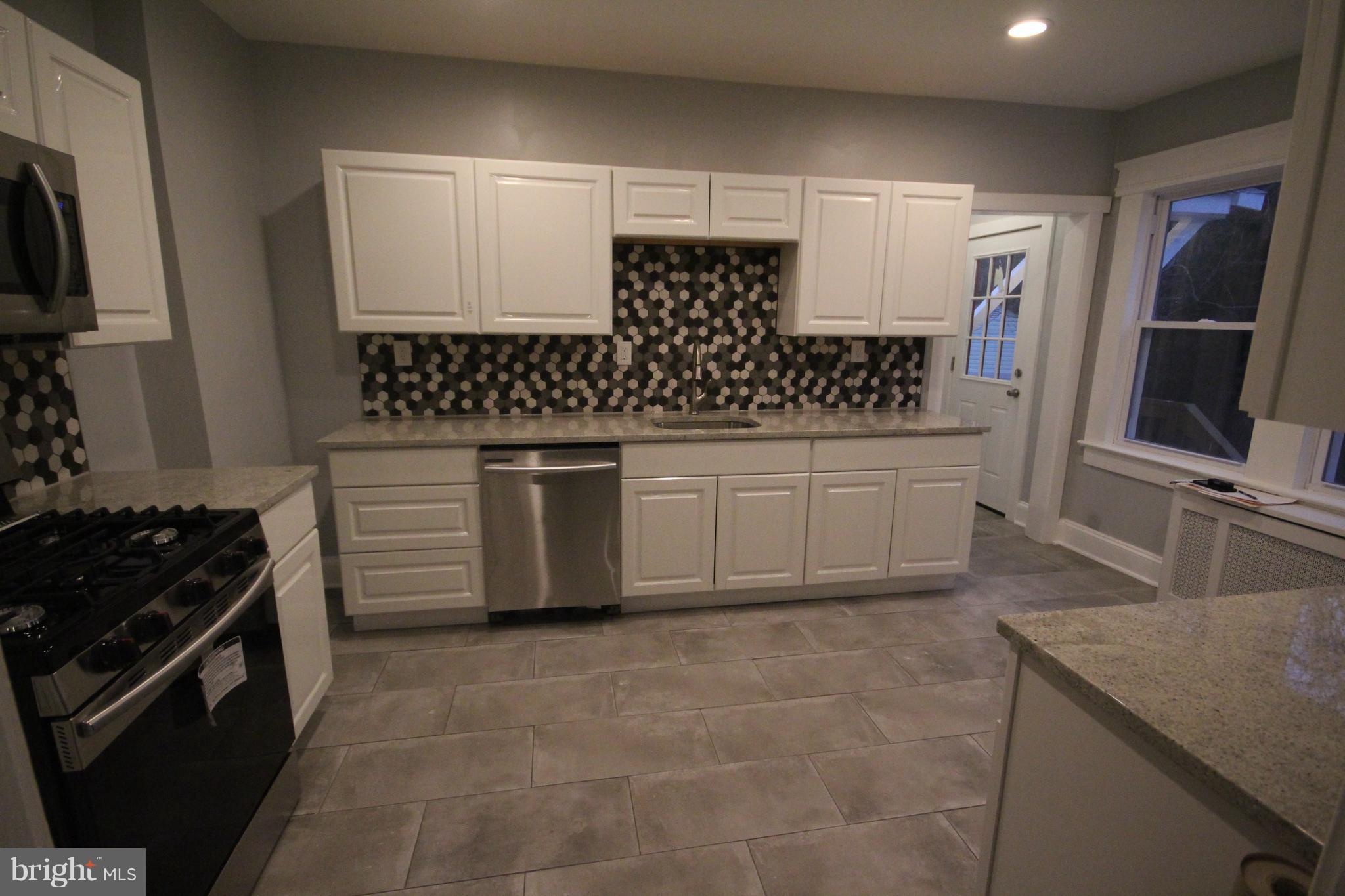 162 Edinburg Road Hamilton, NJ 08619 - Photo 10 of 17 a kitchen with granite countertop a sink and a stove