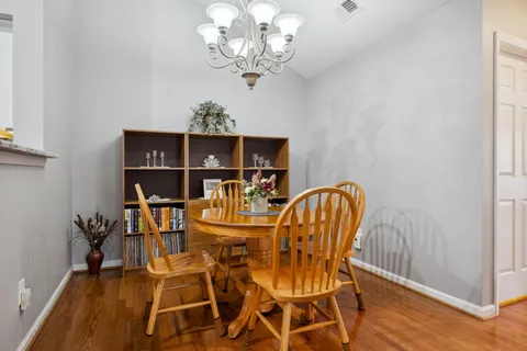 a view of a dining room with furniture and chandelier