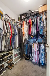 a spacious bedroom with a bed and a flat screen tv