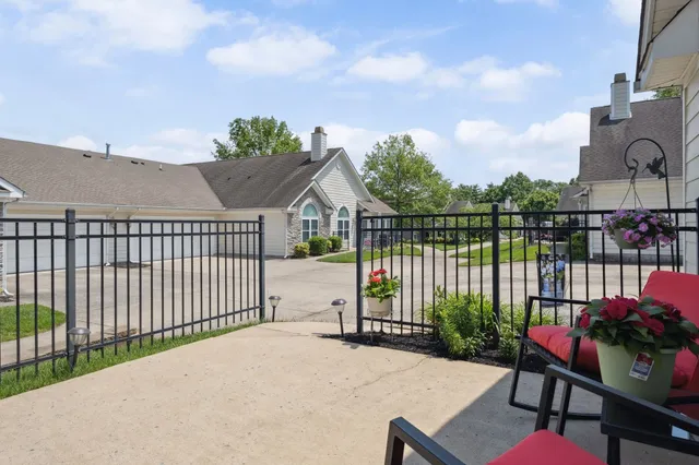 a view of a house with a backyard and sitting area