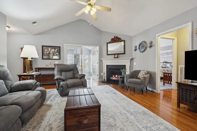 a living room with furniture a flat screen tv and a fireplace
