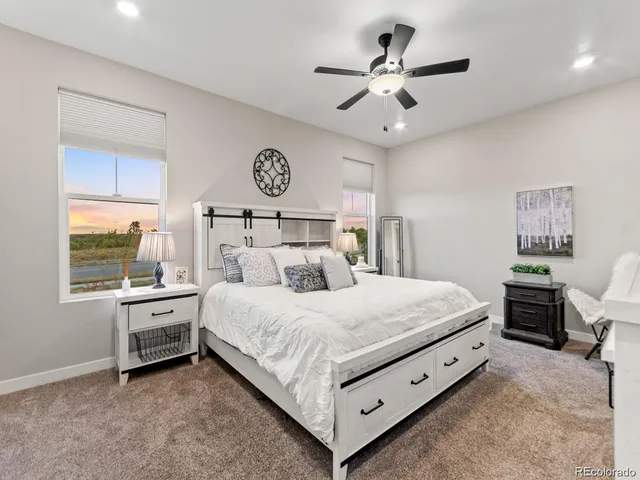 a bedroom with a large bed and a chandelier
