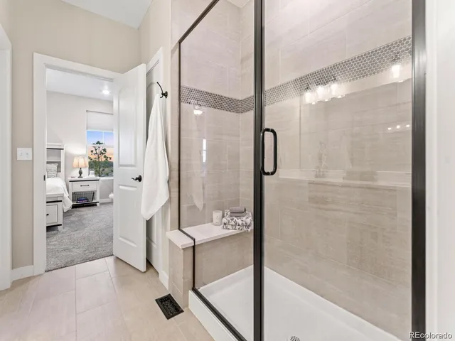 a bathroom with a shower and a mirror