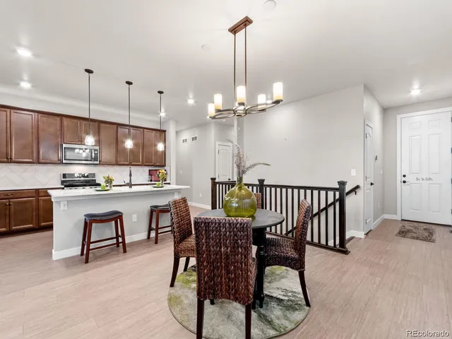 a view of kitchen with furniture and chandelier
