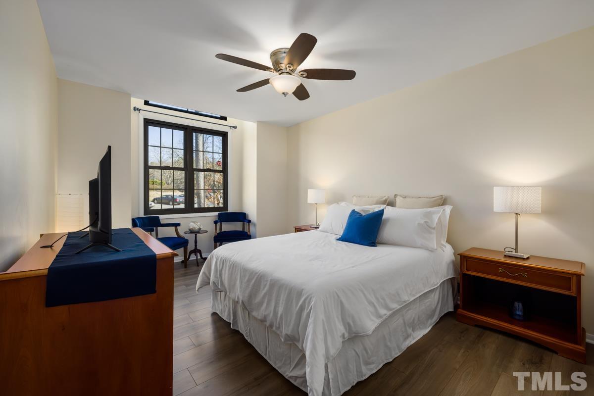 3702 Chimney Ridge Place, Unit 201 Durham, NC 27713 - Photo 11 of 27 a bedroom with a bed and a night stand