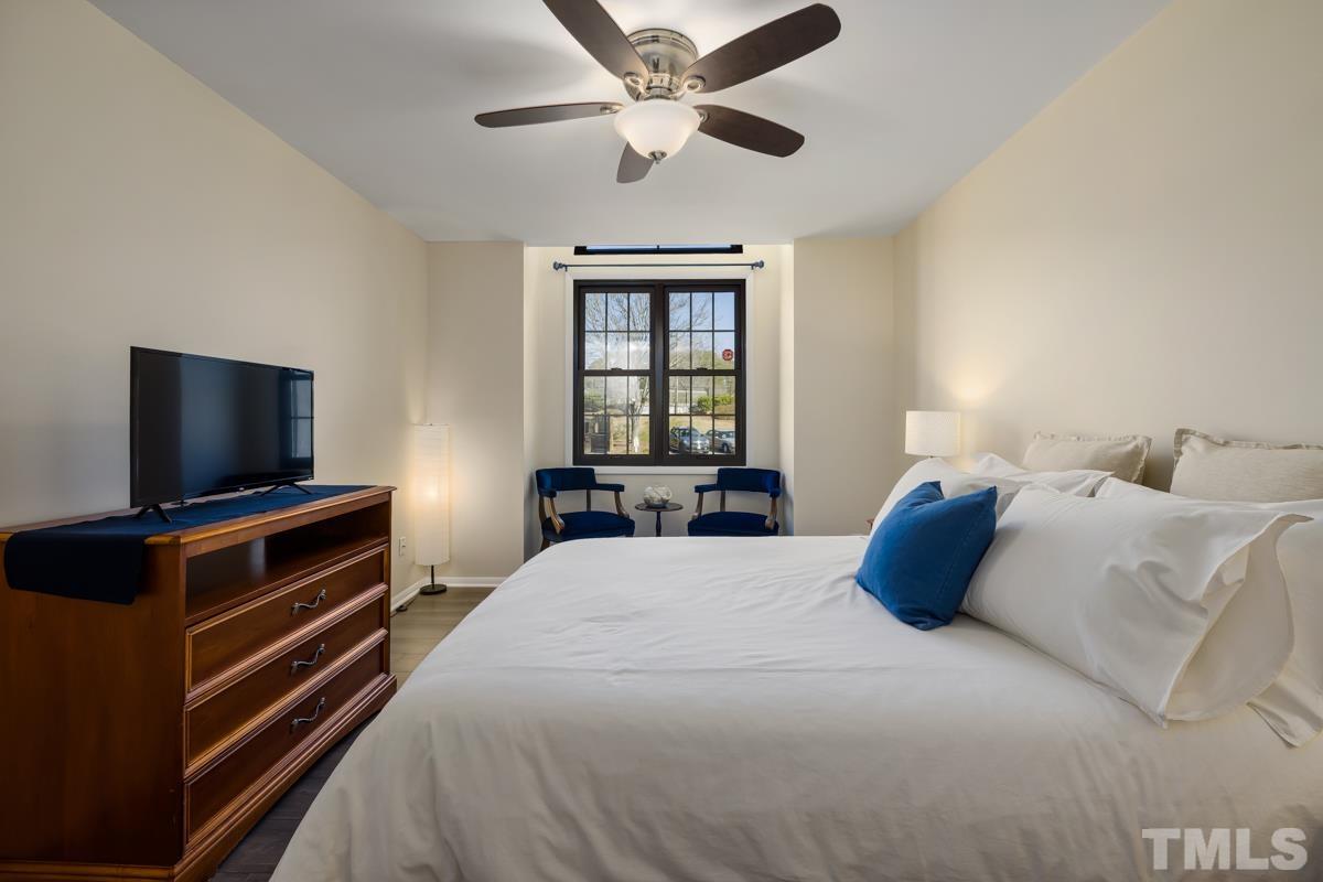 3702 Chimney Ridge Place, Unit 201 Durham, NC 27713 - Photo 12 of 27 a bedroom with a bed and a flat screen tv