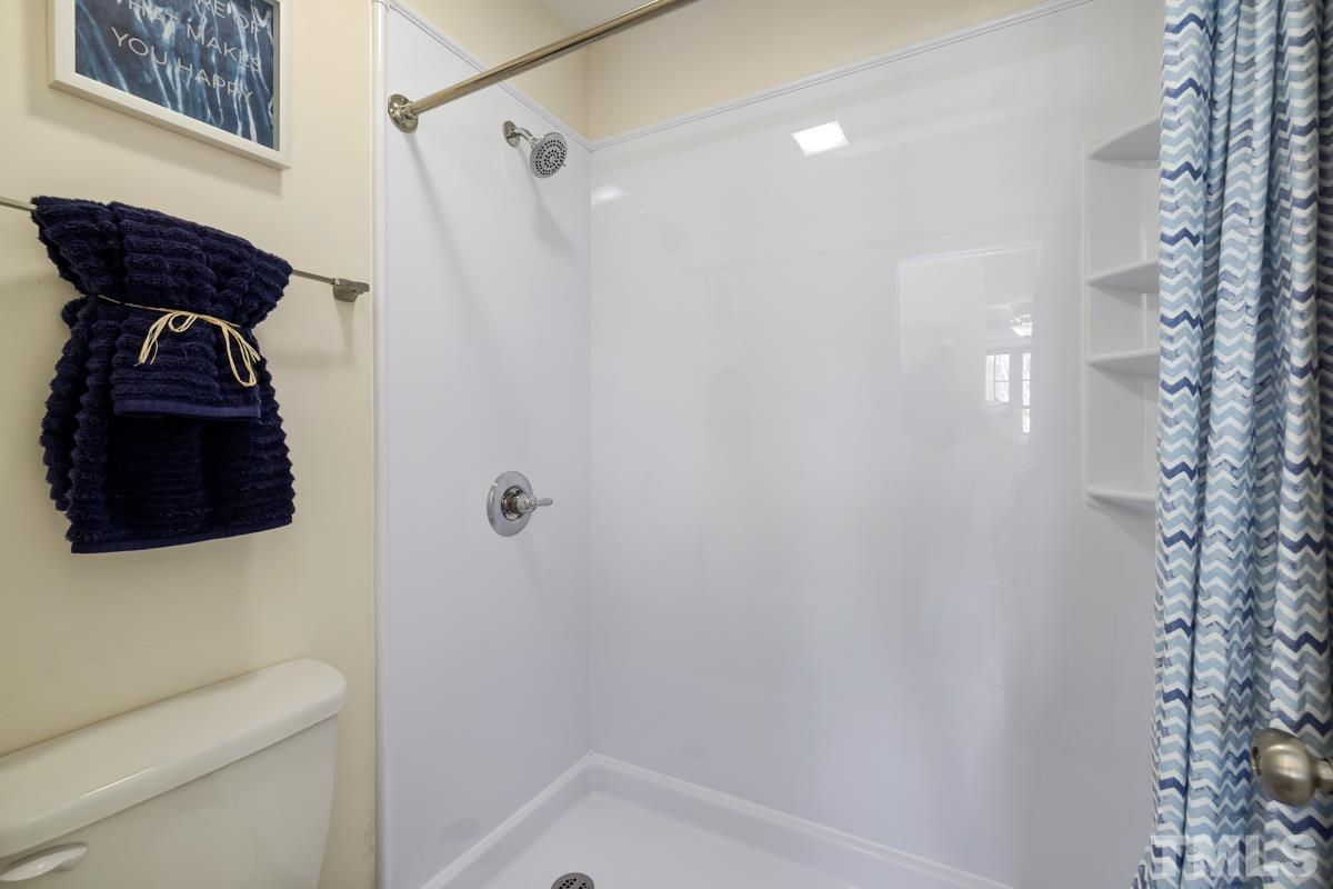 3702 Chimney Ridge Place, Unit 201 Durham, NC 27713 - Photo 15 of 27 a bathroom with a bathtub a shower and a toilet