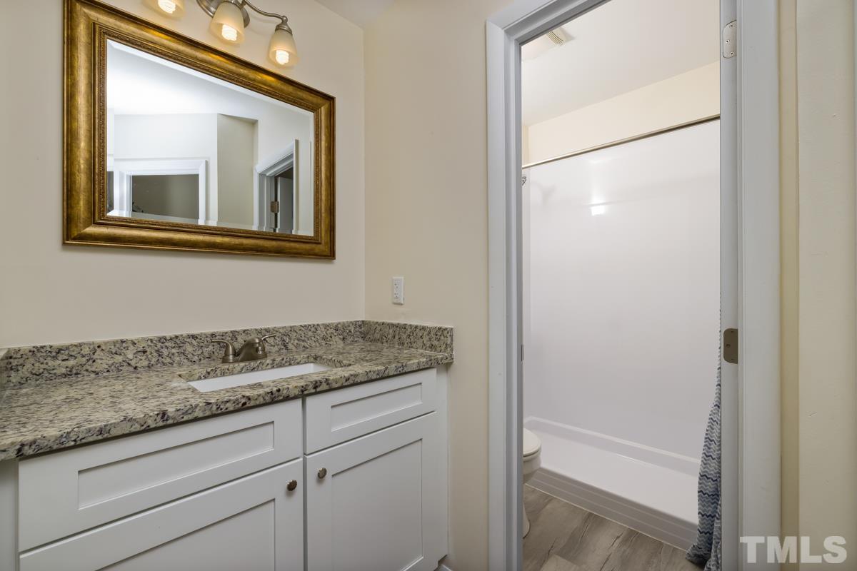 3702 Chimney Ridge Place, Unit 201 Durham, NC 27713 - Photo 16 of 27 a bathroom with a granite countertop sink mirror and vanity