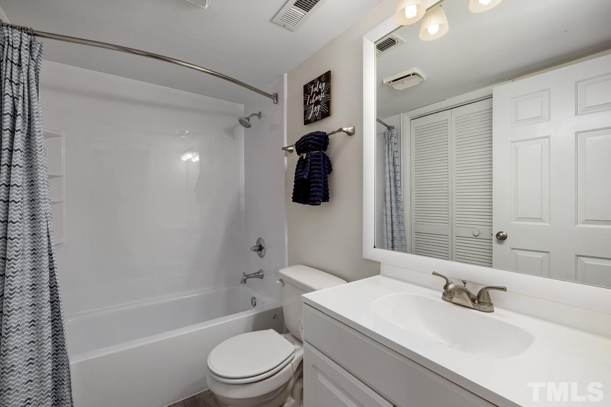 3702 Chimney Ridge Place, Unit 201 Durham, NC 27713 - Photo 20 of 27 a bathroom with a sink a toilet and shower