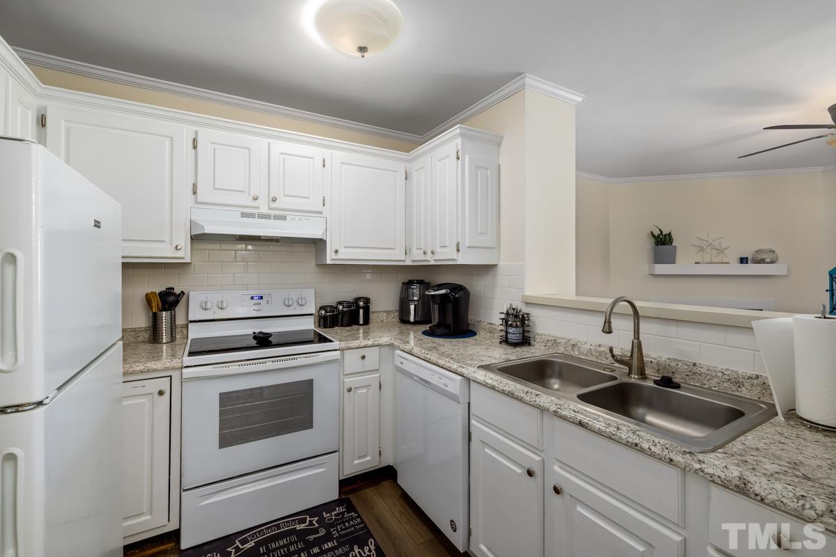 3702 Chimney Ridge Place, Unit 201 Durham, NC 27713 - Photo 7 of 27 a kitchen with white cabinets sink and white appliances