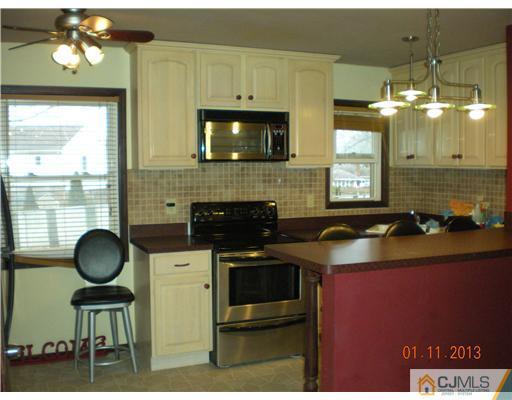 11 Stevens Road Edison, NJ 08817 - Photo 4 of 14 a kitchen with a sink and a stove