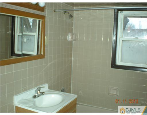11 Stevens Road Edison, NJ 08817 - Photo 7 of 14 a bathroom with a sink and a mirror