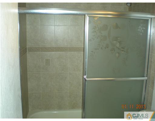 11 Stevens Road Edison, NJ 08817 - Photo 10 of 14 a bathroom with a glass shower door