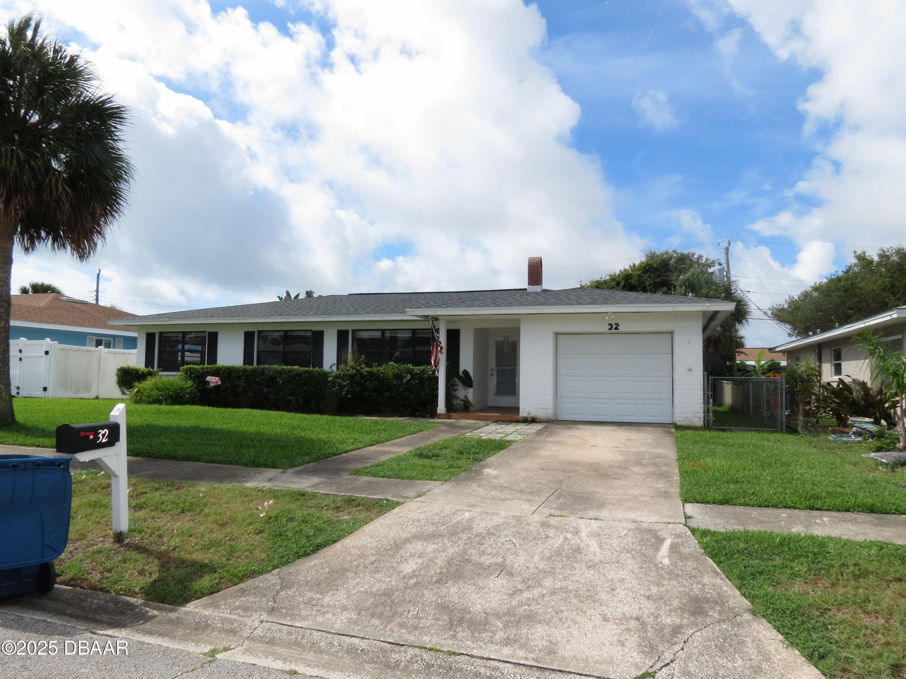 221 Williams Avenue Daytona Beach, FL 32118 - Photo 1 of 15 a front view of a house with a garden and trees