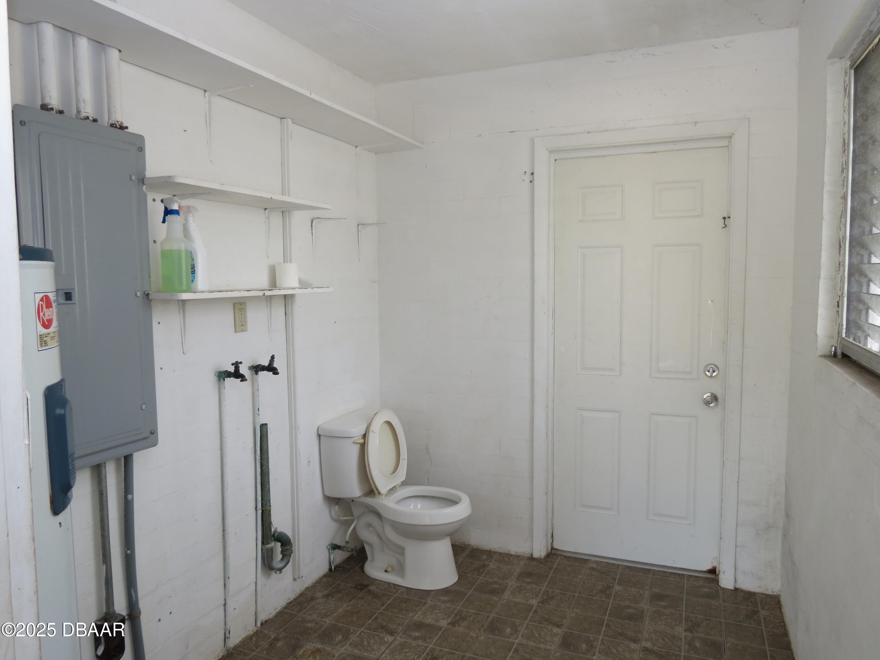 221 Williams Avenue Daytona Beach, FL 32118 - Photo 13 of 15 a bathroom with a toilet and a shower