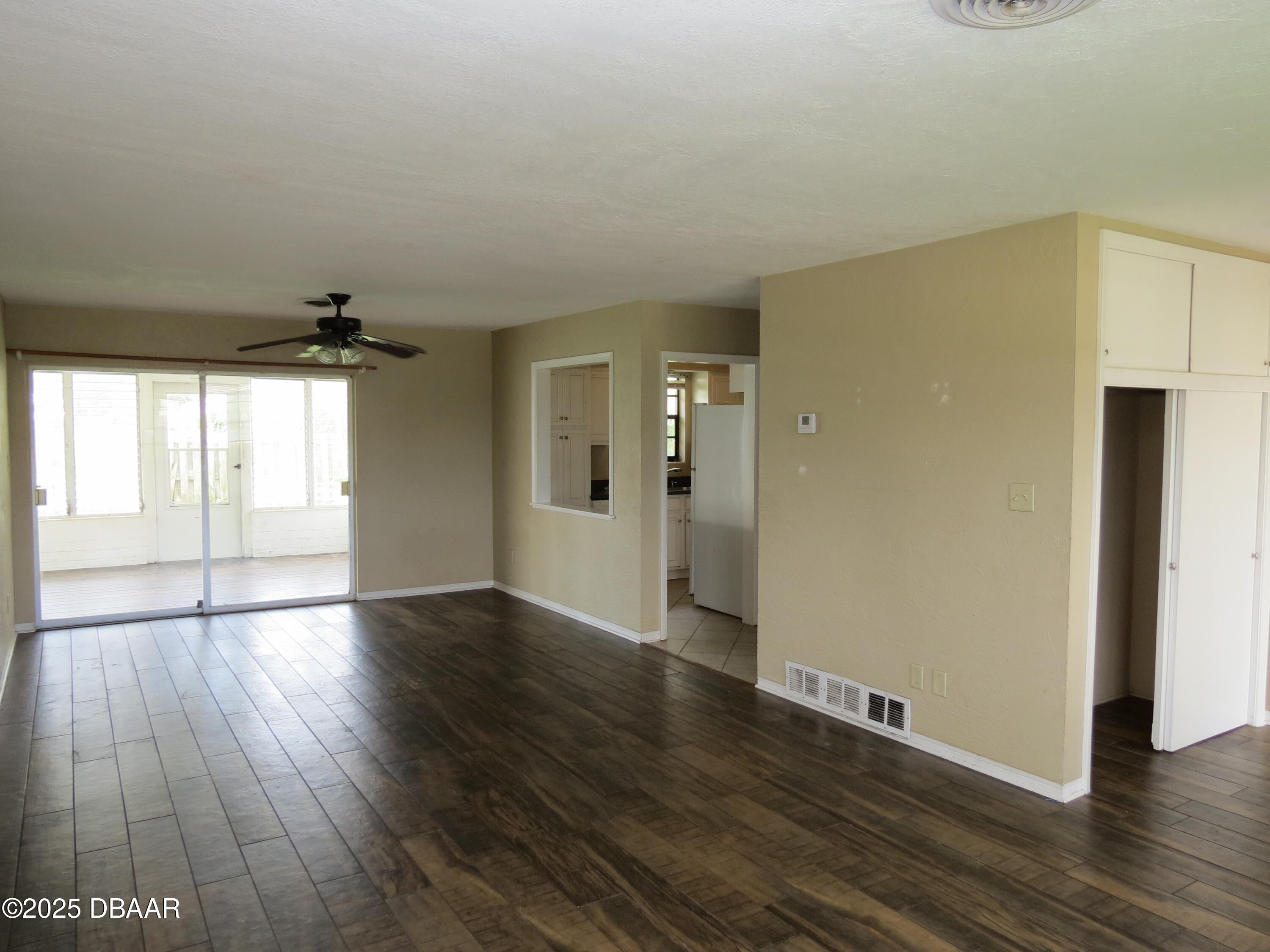 221 Williams Avenue Daytona Beach, FL 32118 - Photo 3 of 15 an empty room with wooden floor and windows
