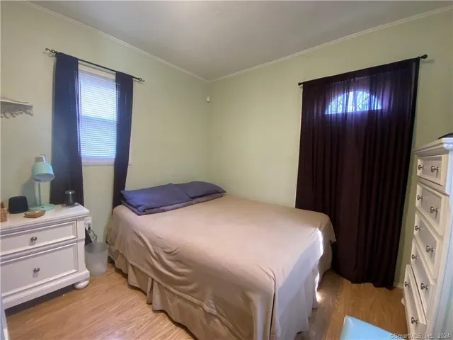 a bathroom with a toilet and a mirror