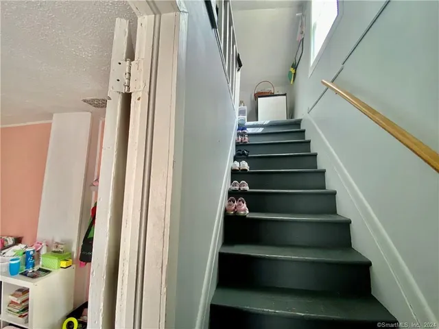 a view of a hallway with workspace and living room