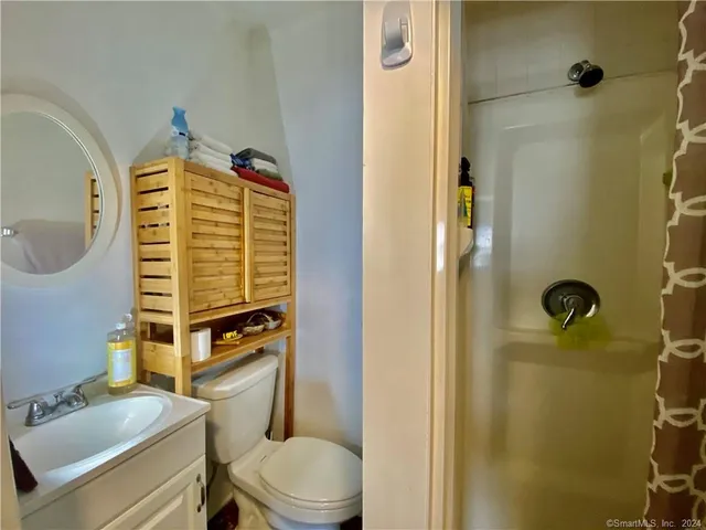 a view of hallway with stairs and wooden floor