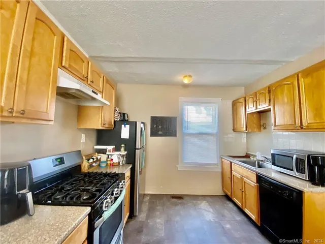 a view of a dining room with furniture and window