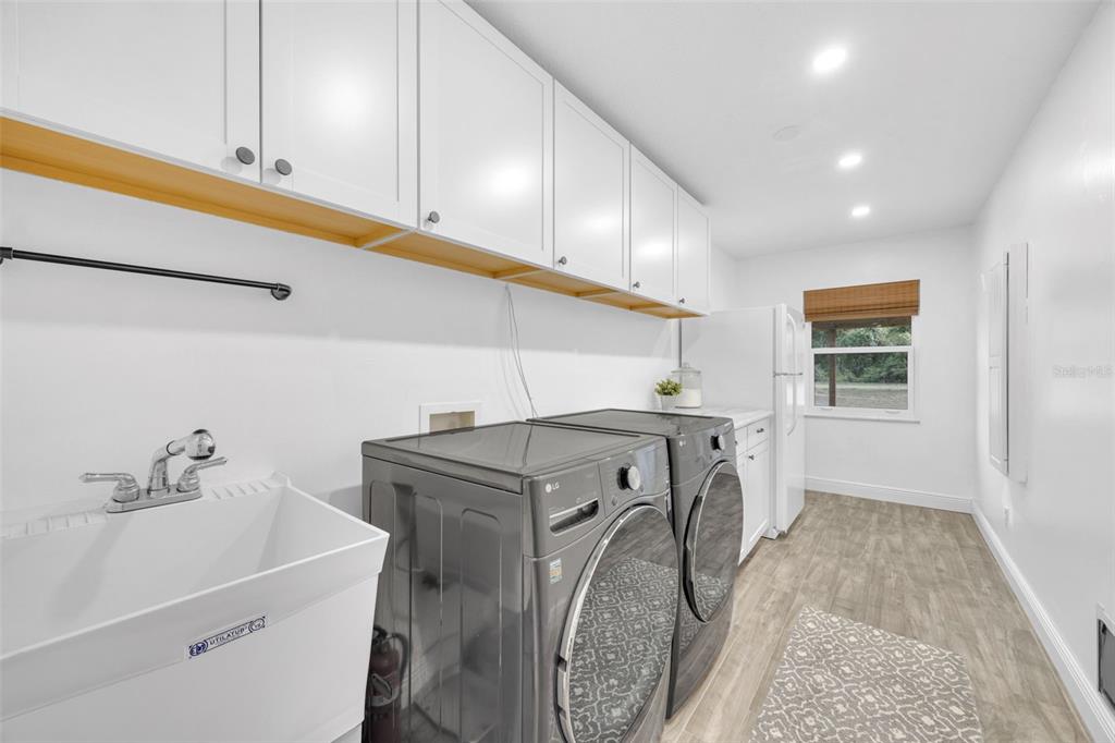 3535 Moores Lake Road Dover, FL 33527 - Photo 33 of 85 The laundry/utility room is so practical! The standup fridge, standup freezer (to right of fridge) and washer/dryer could stay if the buyer adds them to their offer.